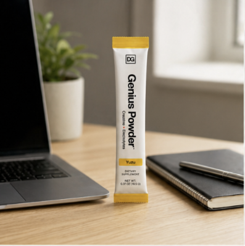 Genius Powder stick pack on a desk next to a laptop