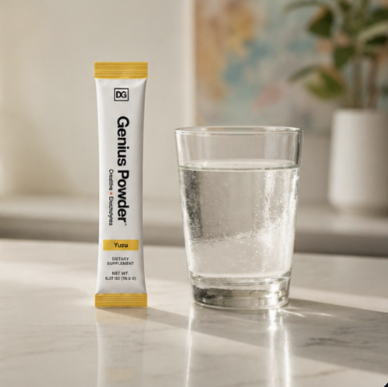 Genius Powder stick pack next to a glass of water